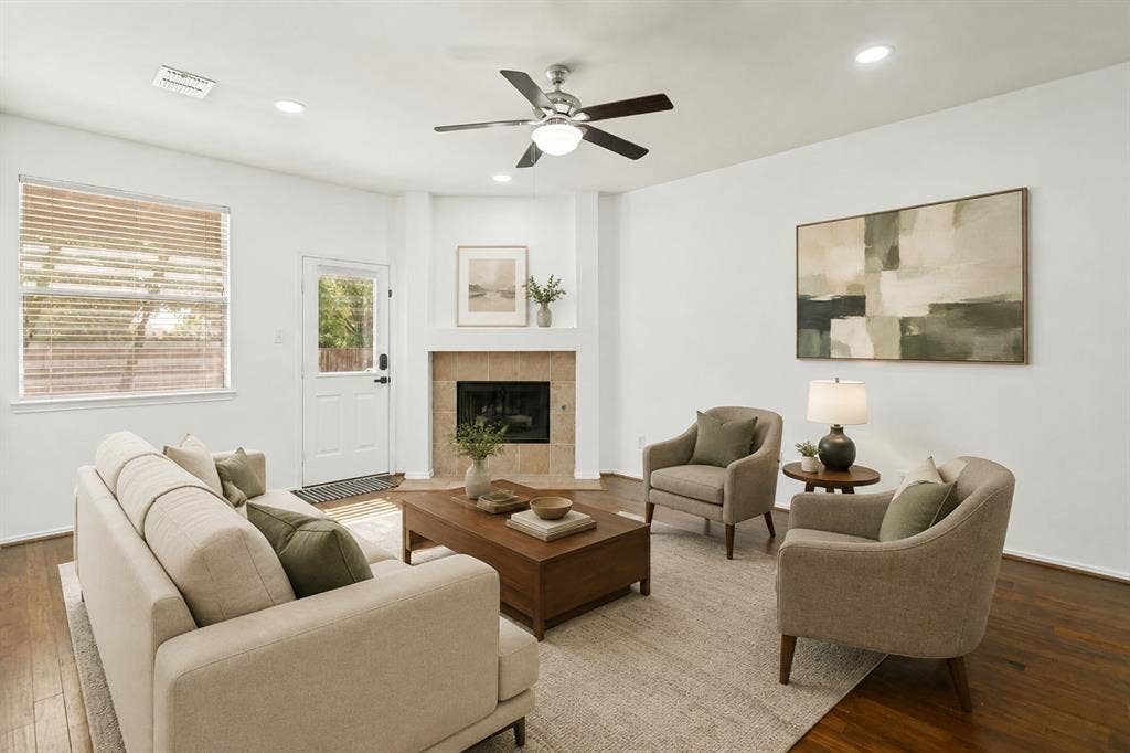 9604 Bull Creek Drive, Plano, TX 75025 Hardwood flooring, corner fireplace with tile surround, ceiling fan with integrated lighting, recessed lighting, and a white paneled door