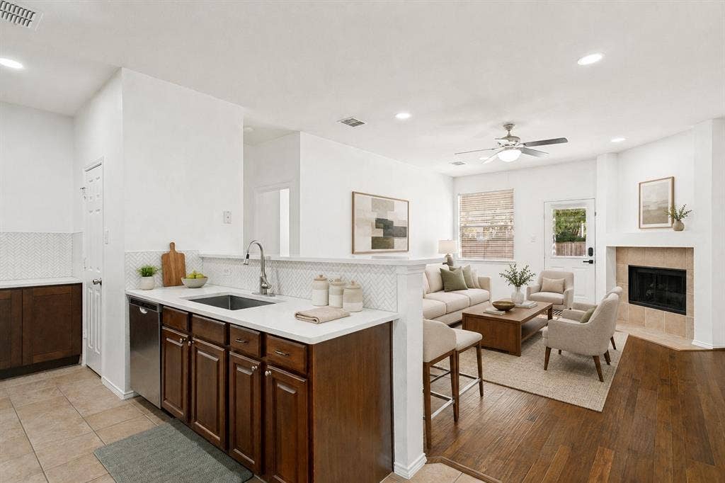 9604 Bull Creek Drive, Plano, TX 75025 Open concept living area featuring a kitchen with stainless steel appliances, white countertops, and a subway tile backsplash