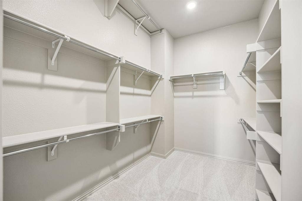 1013 Magdalena Way, Midlothian, TX 76065 Featuring seasonal hanging rods and plenty of space to spread out, your dream owner's closet awaits!