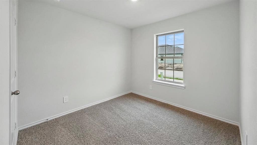 1912 Freeman Street, Tyler, TX 75702 Light-colored wall-to-wall carpeting, white painted walls, and a multi-pane window