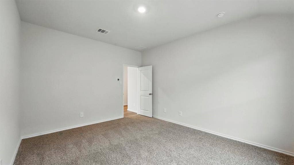 1912 Freeman Street, Tyler, TX 75702 Neutral tone wall paint with carpeted flooring and an overhead light fixture