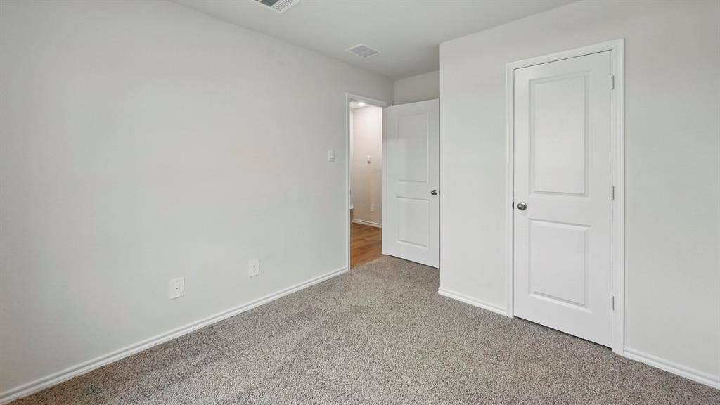 1912 Freeman Street, Tyler, TX 75702 Neutral wall paint, light gray carpeting, and white trim