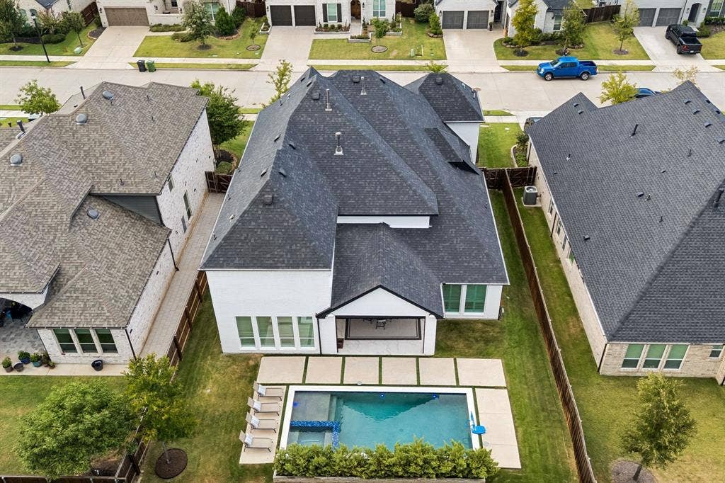 1581 Turnberry Drive, Prosper, TX 75078 Resort-style backyard features a sparkling pool and covered patio - an entertainer's dream