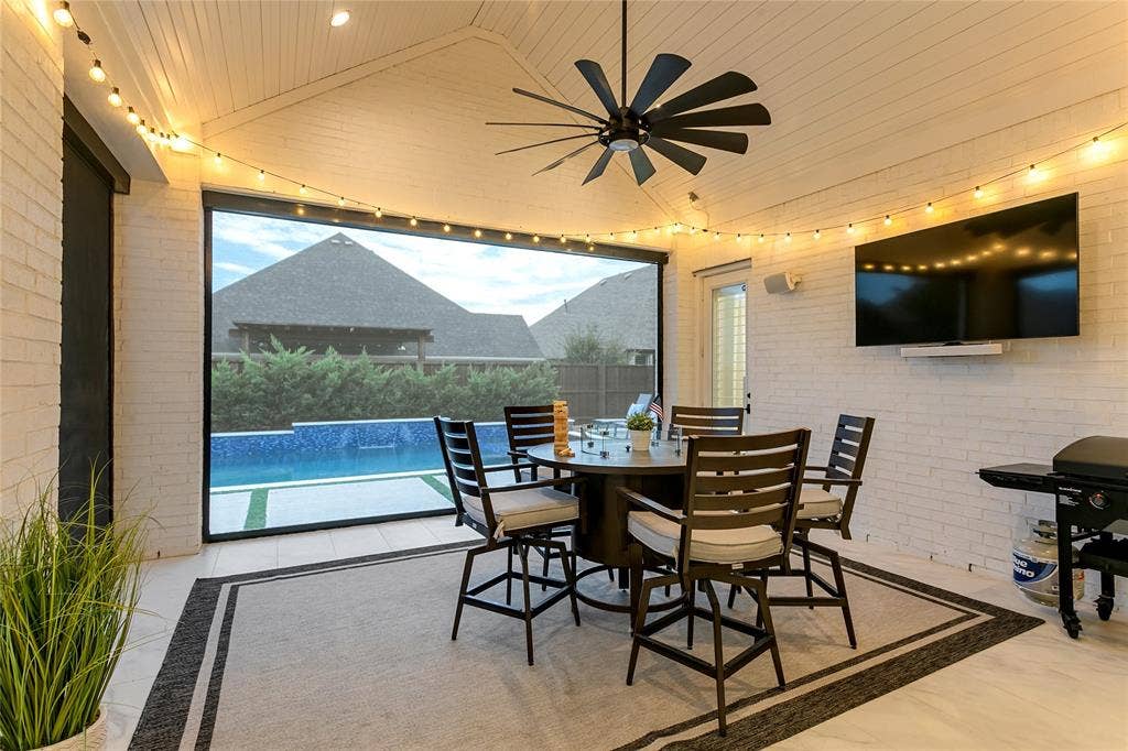1581 Turnberry Drive, Prosper, TX 75078 The patio’s electric screens create an enclosed feel without losing the pool view.