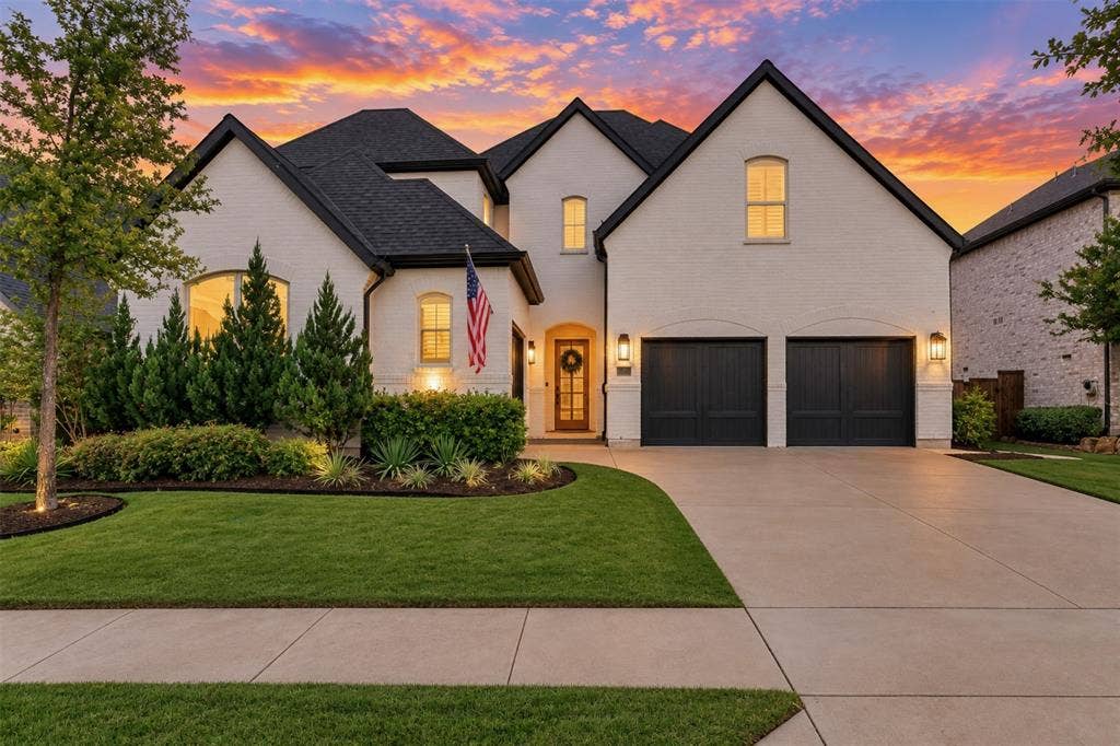 1581 Turnberry Drive, Prosper, TX 75078 Breathtaking twilight curb appeal with painted brick dark trim rooflines and warm entry lighting