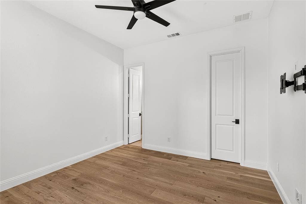 1581 Turnberry Drive, Prosper, TX 75078 Bright secondary bedroom on the first floor with wide-plank hardwood flooring