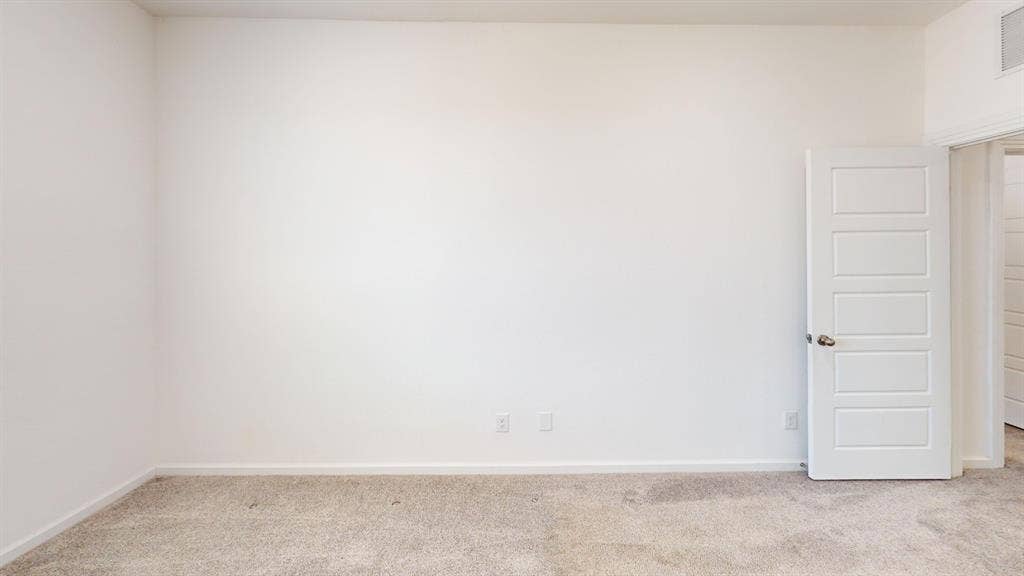366 Buck Ridge Drive, Frisco, TX 75068 Carpeted flooring with white baseboards, a white paneled door with a metallic knob, and white painted walls