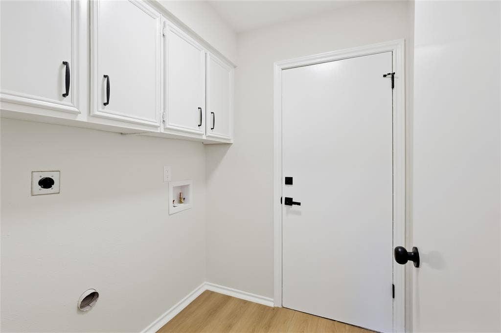White shaker-style cabinetry with matte black hardware