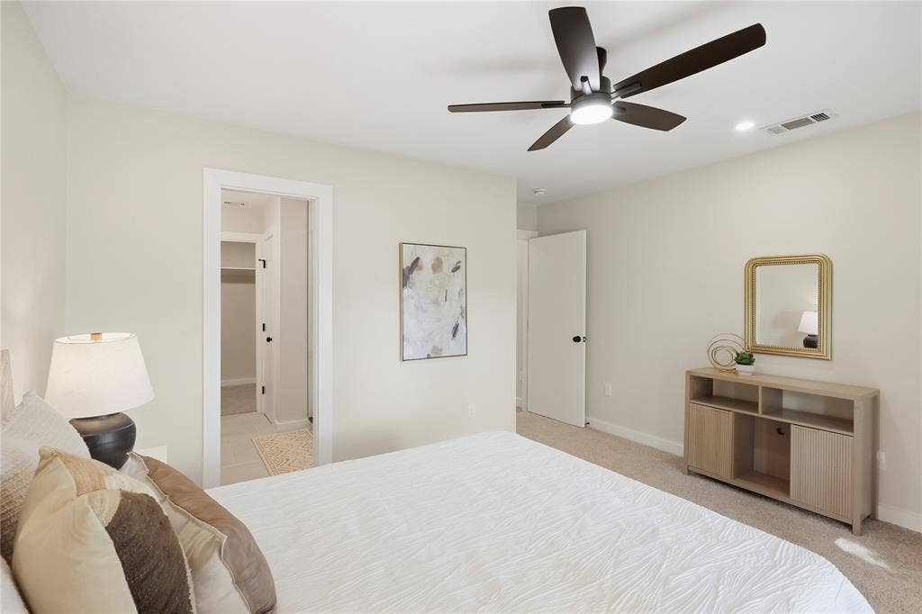 Recessed lighting, ceiling fan with integrated light, and neutral wall tones