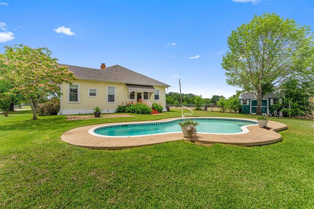 2967 S Old Robinson Road, Robinson, TX 76655 Exterior rear view of the home with in-ground pool sold as-is, large barn style storage building