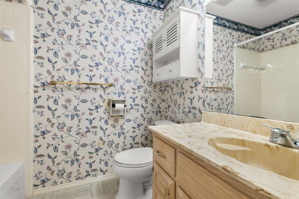 Bathroom featuring a built-in vanity with an integrated sink, a wall-mounted medicine cabinet, and a full-width mirror