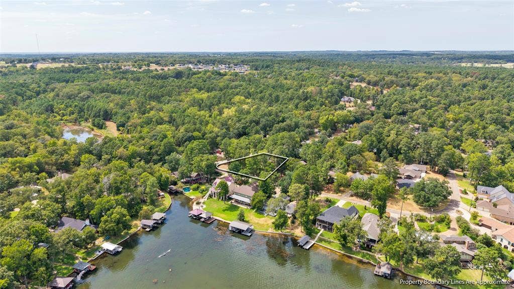 Waterfront estate nestled within mature landscaping and lush woodland surroundings