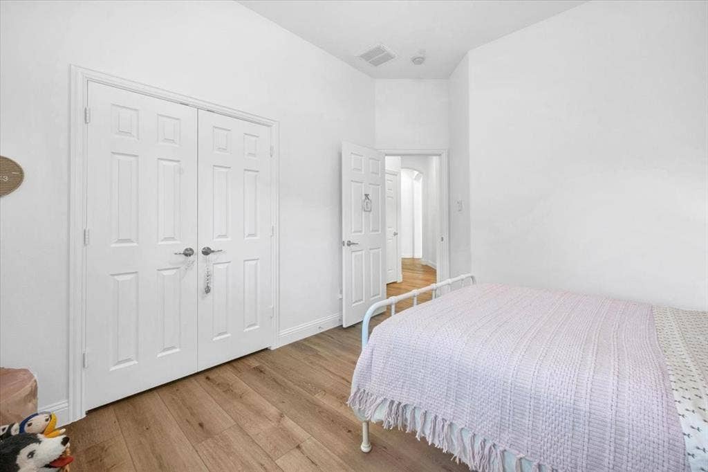 Wood-finish flooring complemented by light-toned walls and white trim