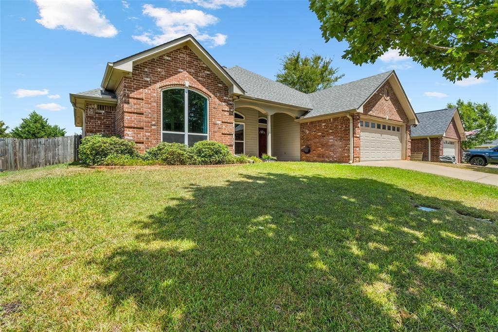 11848 County Road 167, Tyler, TX 75703 Brick and siding exterior with an arched window, attached garage, and a concrete driveway