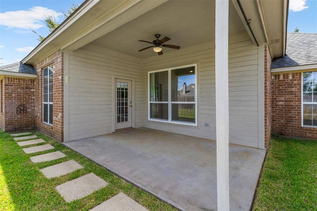 11848 County Road 167, Tyler, TX 75703 Covered patio featuring a ceiling fan, concrete flooring, and an exterior door