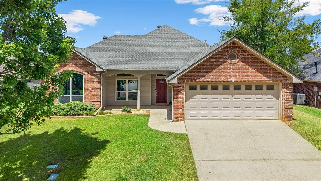 11848 County Road 167, Tyler, TX 75703 Brick and siding exterior with an attached garage, covered entryway, and arched windows