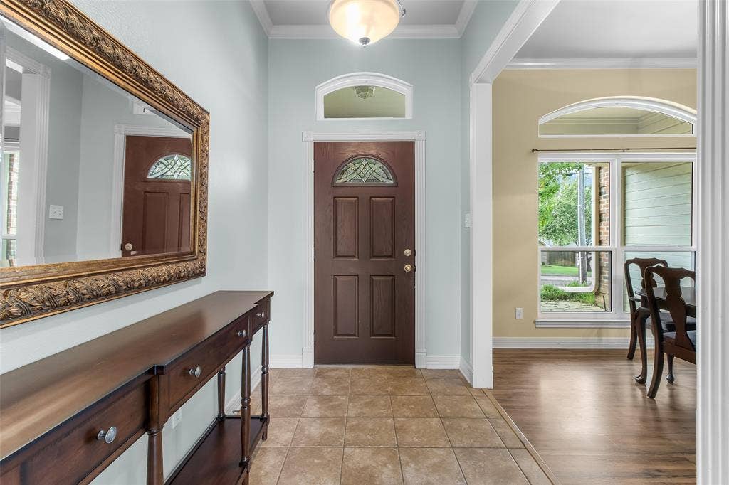 11848 County Road 167, Tyler, TX 75703 Entryway featuring tile flooring, a decorative front door with an arched transom window, and a ceiling-mounted light fixture