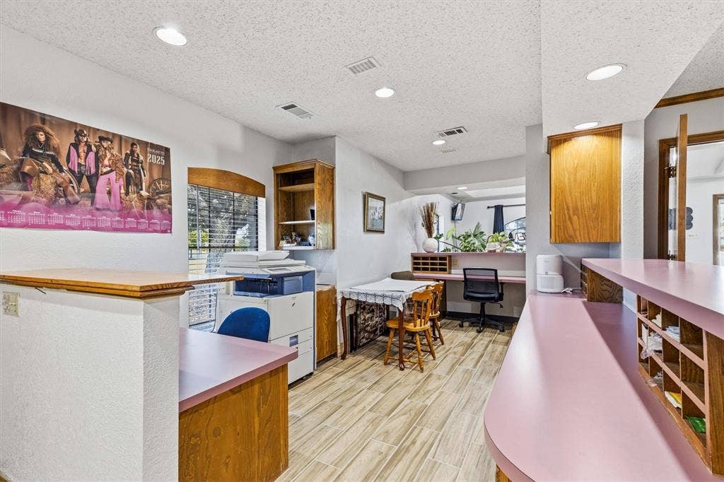 1055 W Pioneer Parkway, Grand Prairie, TX 75051 Recessed lighting, wood-finish flooring, built-in wooden cabinetry, and a countertop with integrated shelving