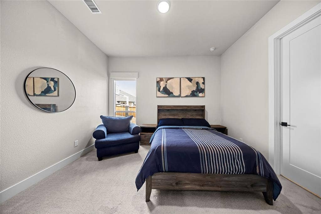 467 Mayfair Lane, Frisco, TX 75033 Carpeted bedroom featuring a window, recessed lighting, and a solid core door with matte black hardware