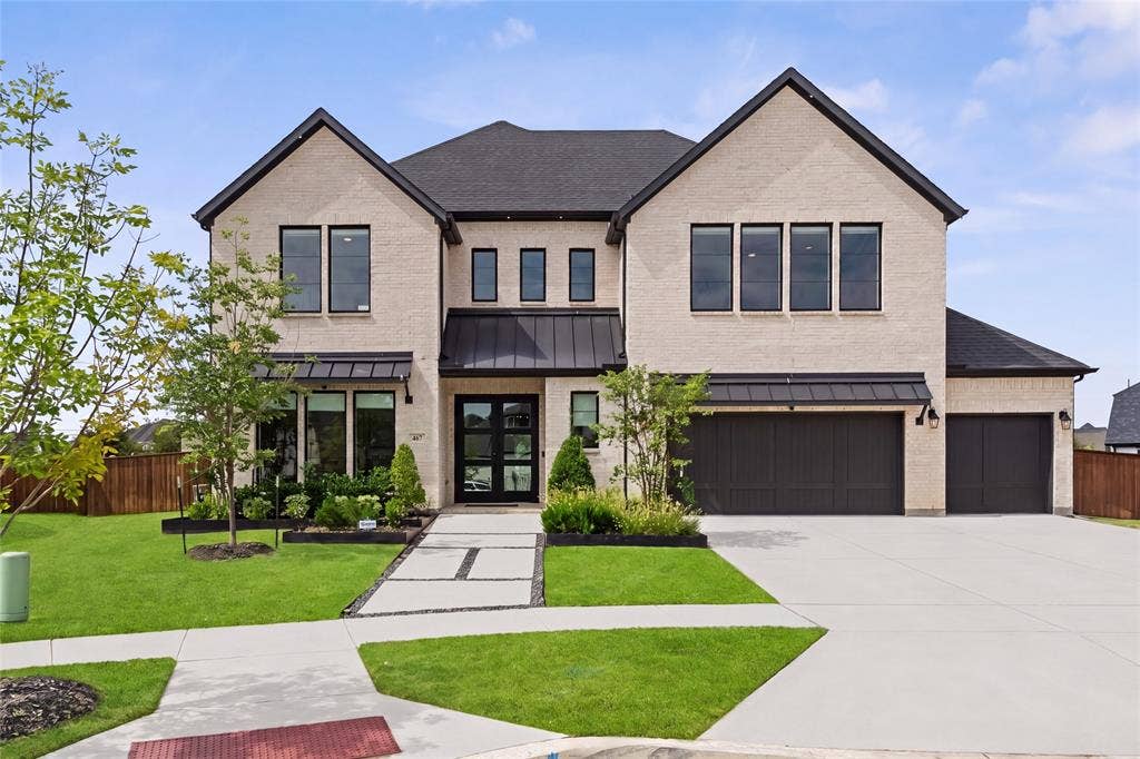 467 Mayfair Lane, Frisco, TX 75033 Brick exterior with dark-framed windows, a black asphalt shingle roof, and a three-car garage