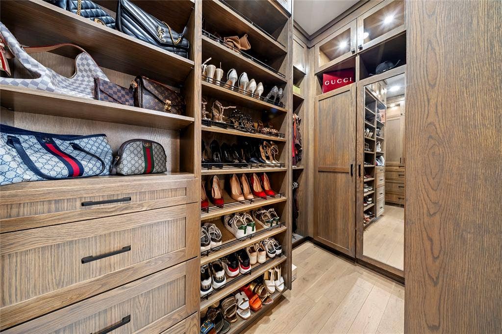 467 Mayfair Lane, Frisco, TX 75033 Custom closet system featuring wood-finish cabinetry, integrated shelving, pull-out drawers, and recessed lighting