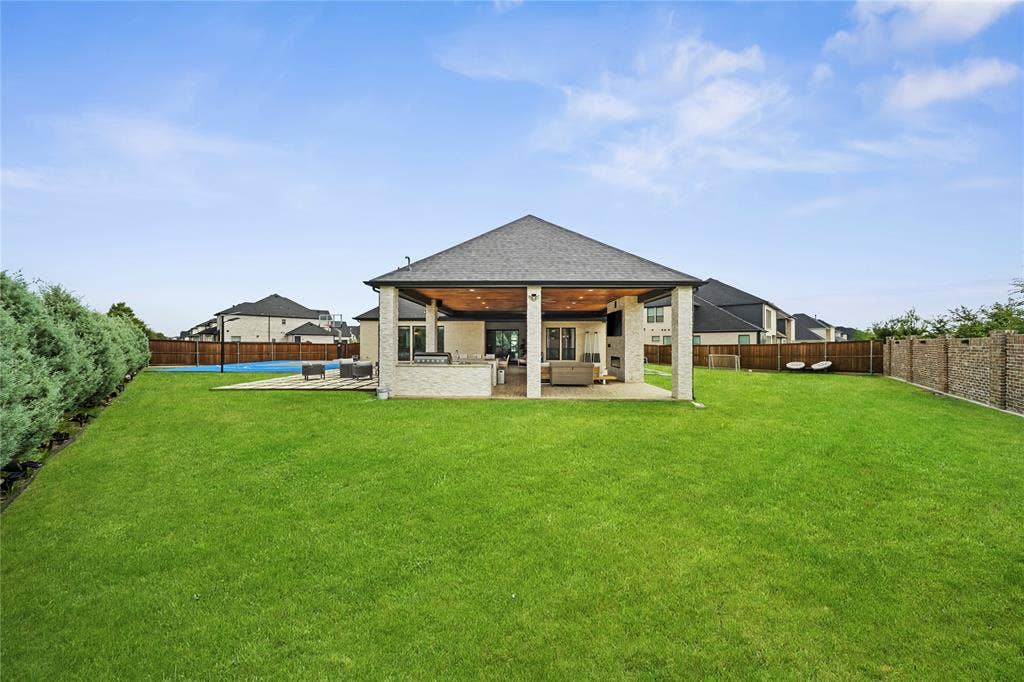 467 Mayfair Lane, Frisco, TX 75033 Expansive green lawn, covered patio with recessed lighting, integrated outdoor kitchen, and a sport court