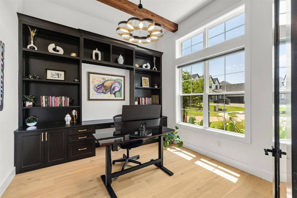 1561 Saint Peter, Prosper, TX 75078 Custom built-in cabinetry with desk space, light wood-finish flooring, exposed wood beam, large windows, and a modern chandelier