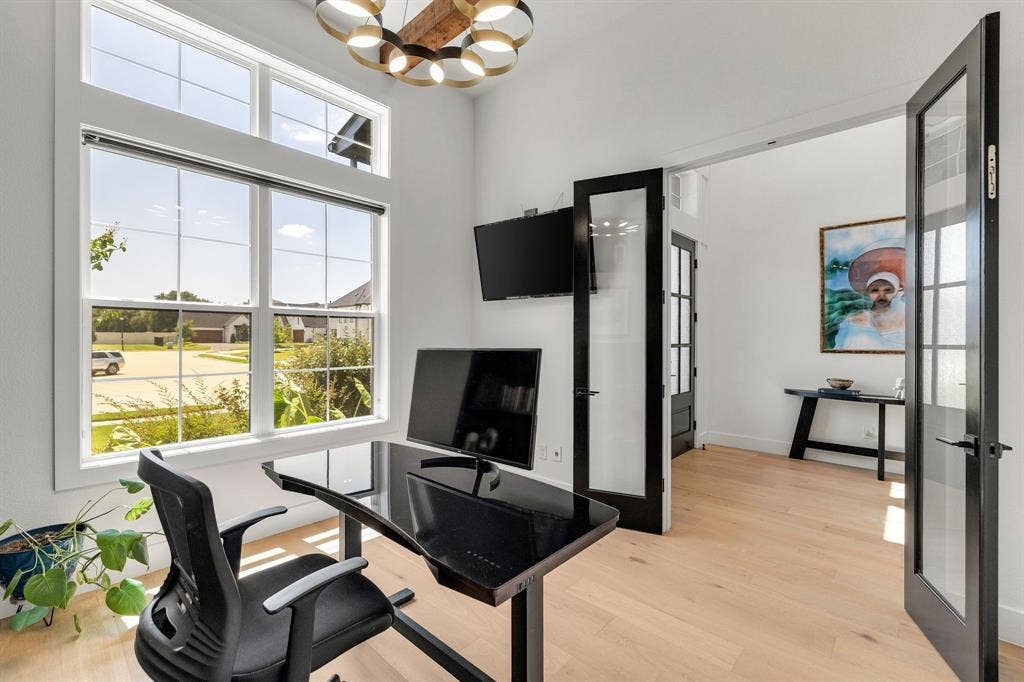 1561 Saint Peter, Prosper, TX 75078 High ceilings with an architectural light fixture, wood-finish flooring, and black-framed French doors