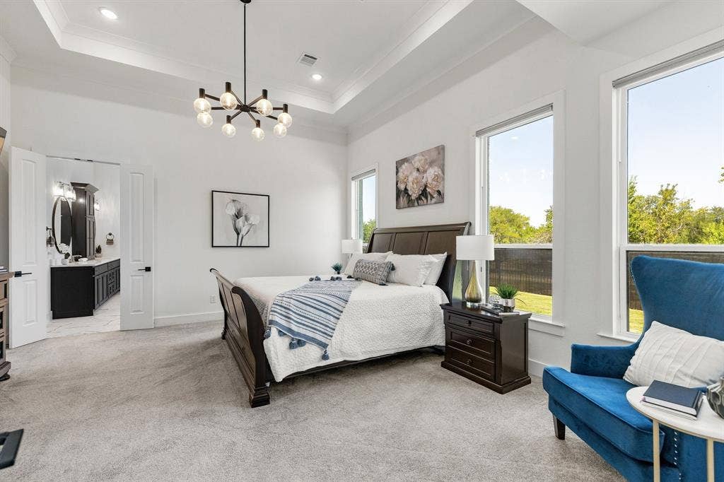 1561 Saint Peter, Prosper, TX 75078 Tray ceiling with recessed lighting and a contemporary chandelier