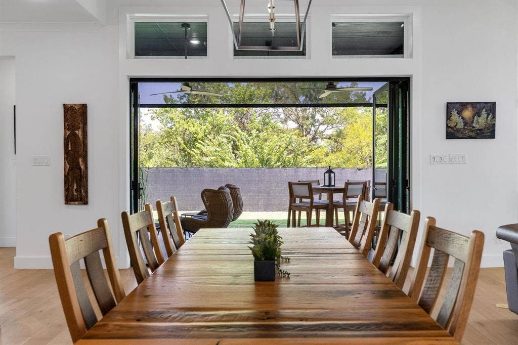 1561 Saint Peter, Prosper, TX 75078 Sophisticated dining space showcasing a wood-finish table with seating for ten, illuminated by pendant lighting