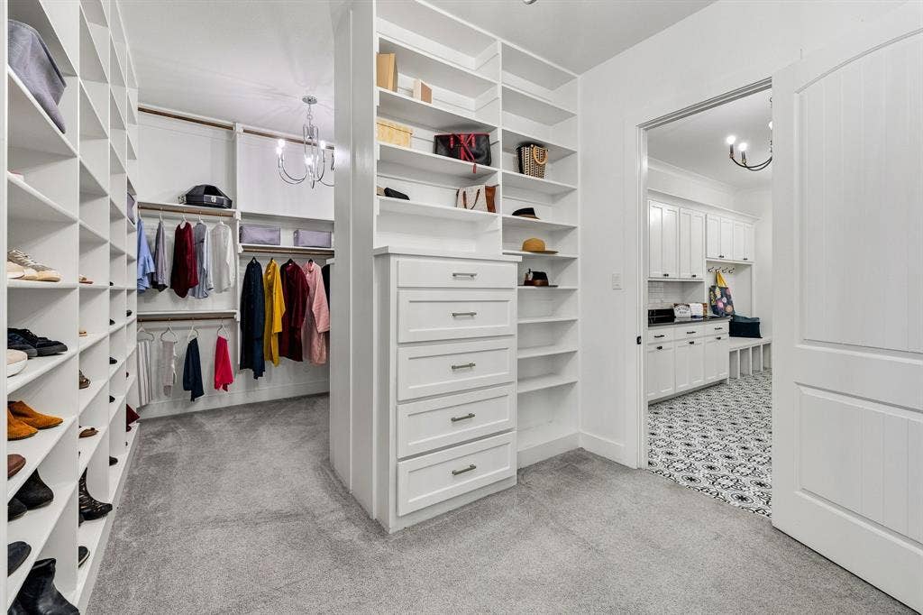 1561 Saint Peter, Prosper, TX 75078 Custom closet system featuring extensive shelving, built-in drawer storage, and hanging rods