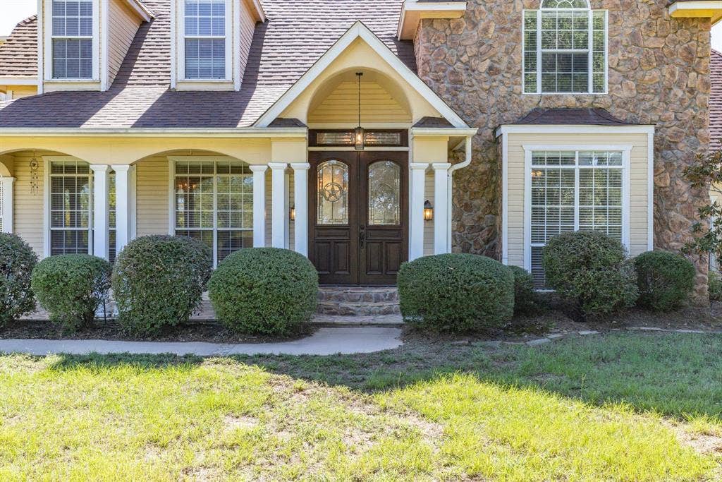 1200 County Road 2307, Sulphur Springs, TX 75482 stunning stone and wood home; 5000+ sq ft, 5 bedrooms, 4.5 baths, 3 living areas, 3- car garage, sweeping porches with beautiful pasture views