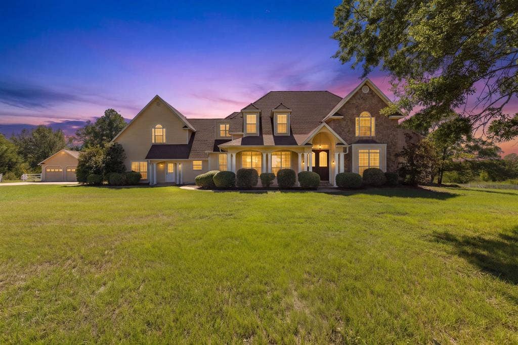 1200 County Road 2307, Sulphur Springs, TX 75482 Twilight view of house.