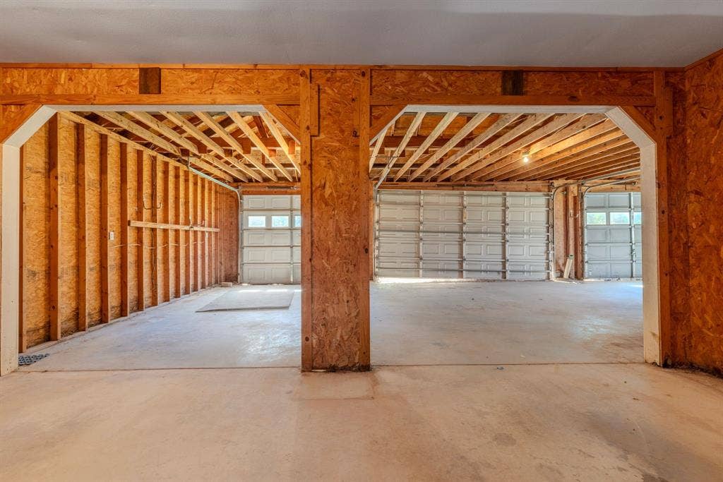 1200 County Road 2307, Sulphur Springs, TX 75482 HUGE workshop has approx 2000 sf, 6 garage doors, central room, electricity, floored attic.