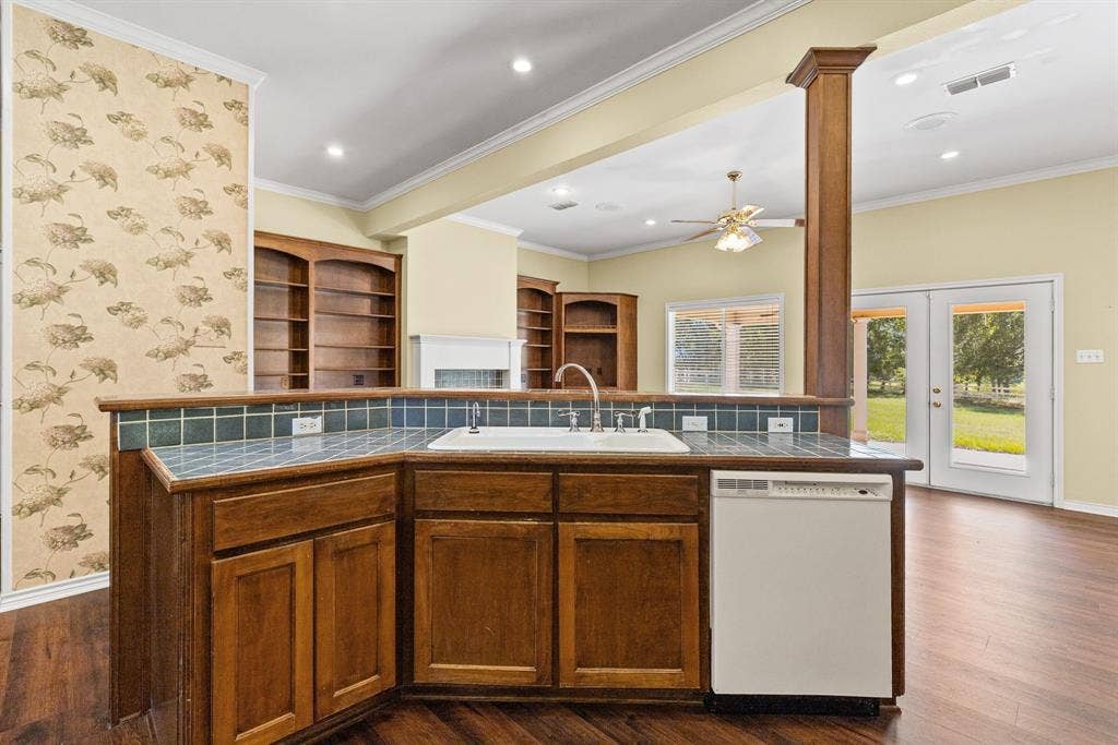 1200 County Road 2307, Sulphur Springs, TX 75482 Kitchen has island with breakfast bar, view of the great room and back porch.