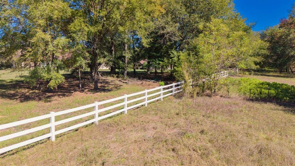 1200 County Road 2307, Sulphur Springs, TX 75482 Front acreage surrounding the house has white fencing, stands of mature trees.