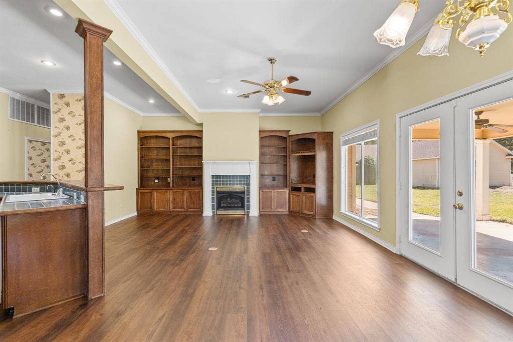 1200 County Road 2307, Sulphur Springs, TX 75482 The great room off the kitchen has tiled fireplace, built-in bookcases, high beamed ceilings, and french doors to the back porch.