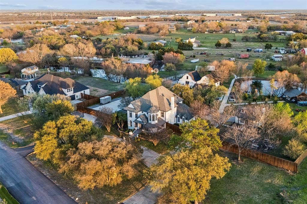 3706 Castle Drive, Rowlett, TX 75089 Spacious property featuring a large residence with a multi-gabled roof, surrounded by mature trees