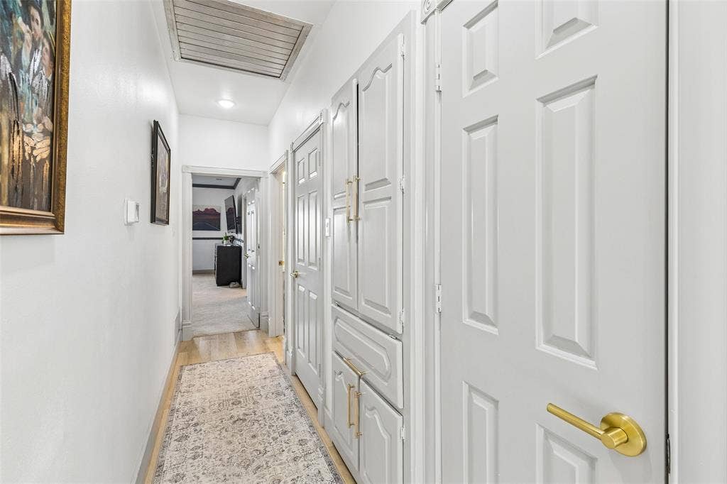 3706 Castle Drive, Rowlett, TX 75089 Hallway with wood-finish flooring, recessed lighting, and built-in cabinetry