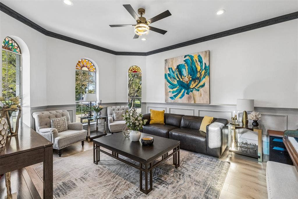 3706 Castle Drive, Rowlett, TX 75089 Arched windows with decorative glass, crown molding, wood-finish flooring, recessed lighting, and a ceiling fan with integrated lighting
