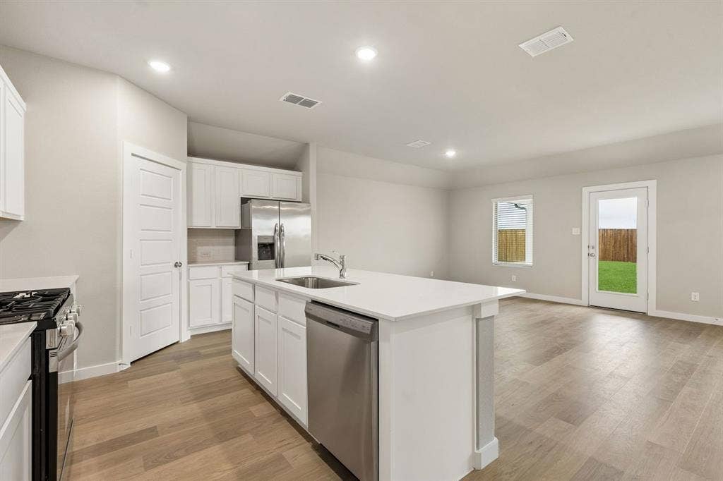 707 Edgehurst Drive, Princeton, TX 75071 Kitchen in the Emmy II home plan by Trophy Signature Homes - REPRESENTATIVE PHOTO