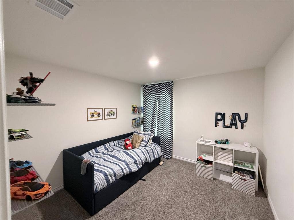 1602 Maple Ridge Drive, Princeton, TX 75407 Recessed ceiling lighting, wall-mounted shelving, white wall paint, patterned window treatments, and gray carpeting