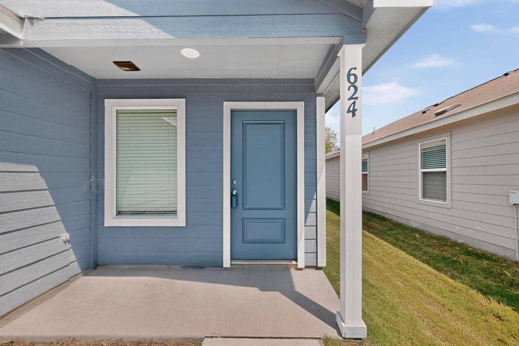 624 Kinglet Lane, Princeton, TX 75407 Entryway featuring a blue door, siding exterior, recessed lighting, and a concrete patio