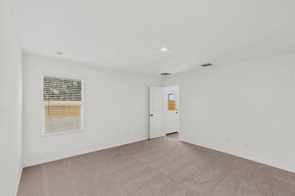 624 Kinglet Lane, Princeton, TX 75407 Neutral tone wall finishes, recessed lighting, and soft gray carpeting