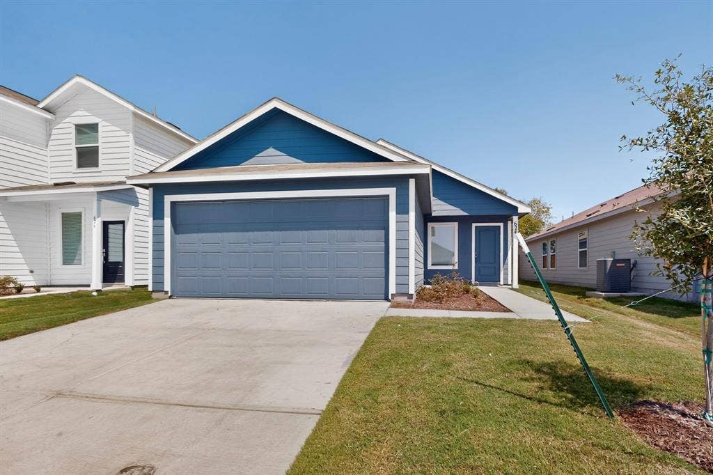 624 Kinglet Lane, Princeton, TX 75407 Contemporary facade with blue siding, attached garage, and concrete driveway