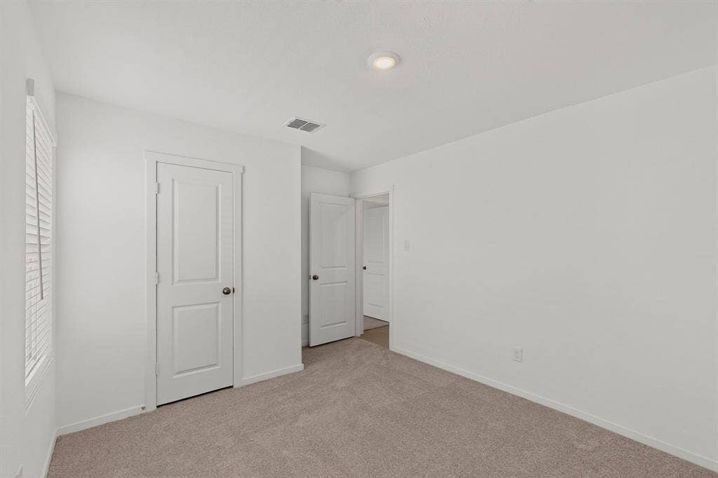 624 Kinglet Lane, Princeton, TX 75407 Neutral wall paint, recessed lighting, white interior doors, and plush carpet flooring