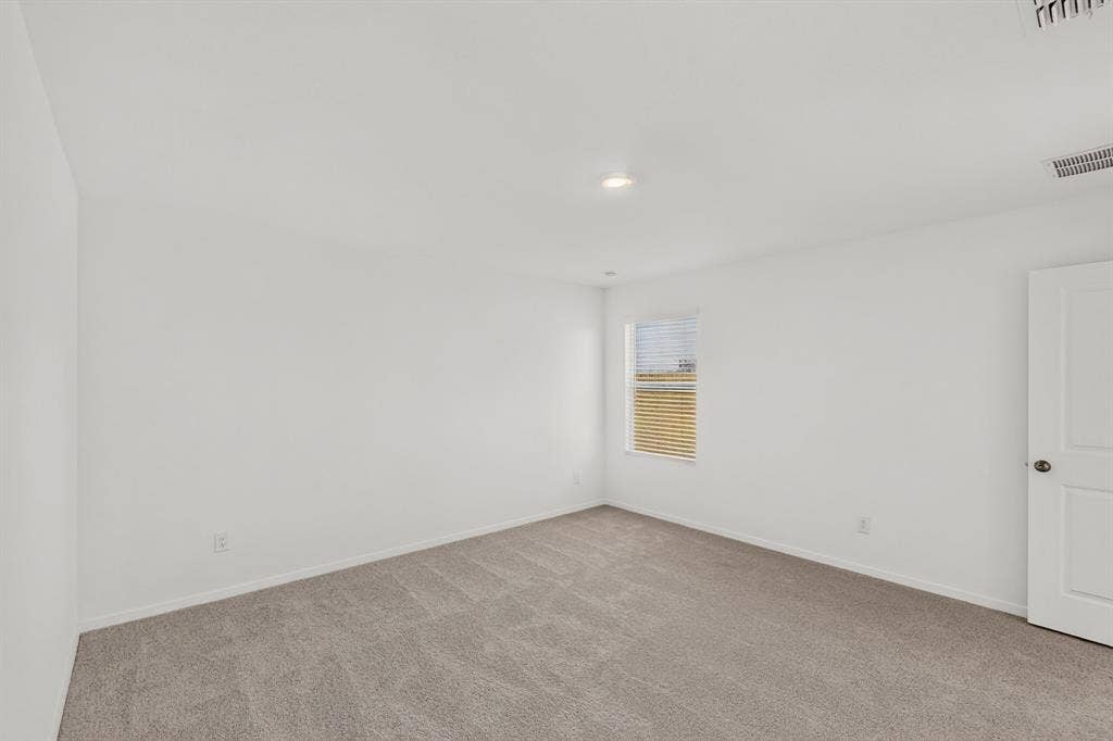 624 Kinglet Lane, Princeton, TX 75407 Recessed lighting, neutral wall paint, light gray carpet, window with blinds, and white interior door