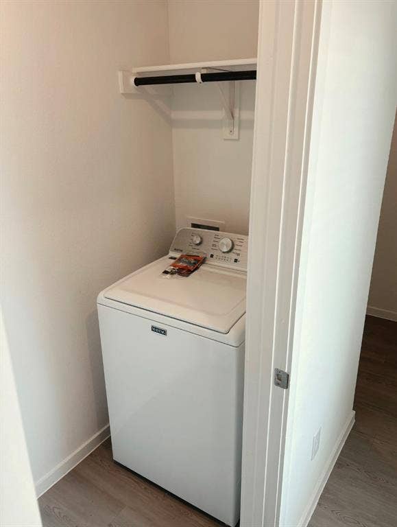 624 Kinglet Lane, Princeton, TX 75407 Laundry closet with a top-load washer, overhead shelving, and wood-finish flooring