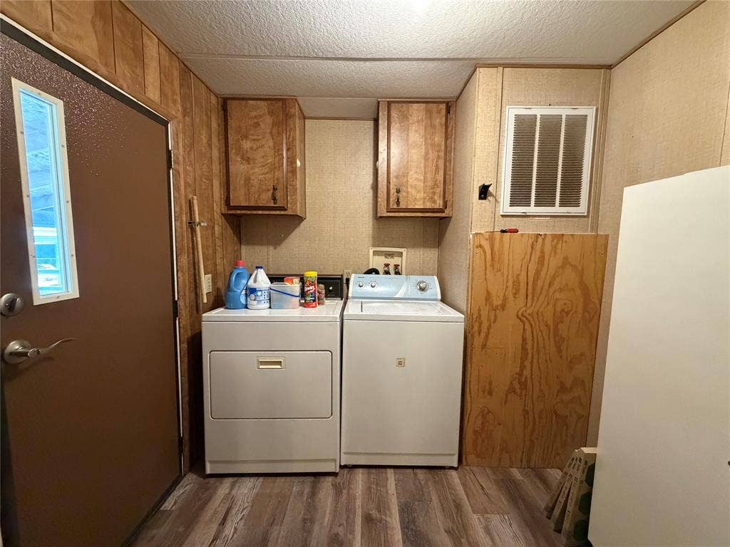 Wood-finish flooring with a utility door and two wall-mounted wood-finish cabinets