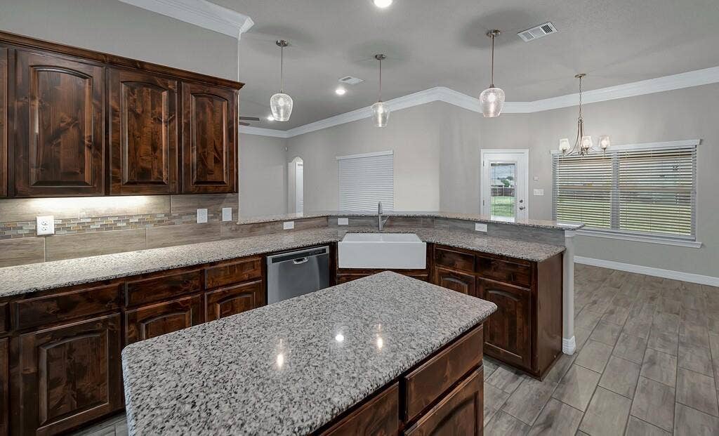 279 Sportsman Drive, Lorena, TX 76655 Wood-finish cabinetry paired with light-toned countertops